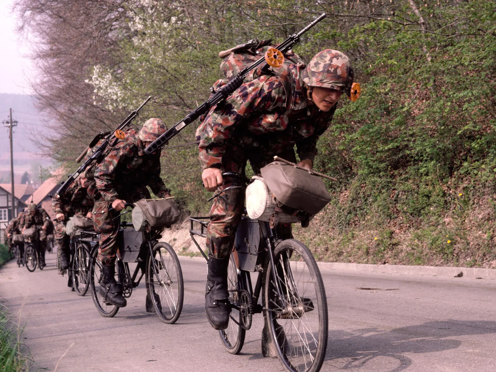 A bicycle troop negotiating a hill in full battle gear, 1981.