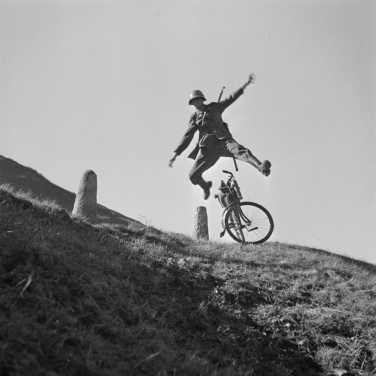 A soldier jumping over his bike’s handlebars on a mountain pass, circa 1935. Photo by Karl Egli.