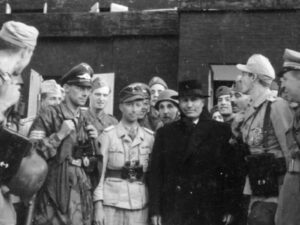 Benito Mussolini (in the middle) with his “liberators” on 12 September 1943 at Gran Sasso in the Apennine mountains. Major Harald Mors, the German officer who played a key part in the raid, is the man next to Mussolini in the light uniform and dark cap.