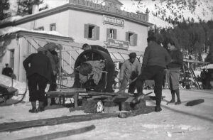 At Morteratsch railway station, director Arnold Fanck (far right) watches equipment being loaded on to a sled.