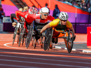 Edith Wolf-Hunkeler (au milieu), athlète en fauteuil suisse et multiple médaillée d’or aux Jeux Paralympiques. Ici en pleine course lors des Jeux paralympiques de Londres, en 2012.