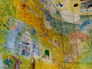 Dans la partie supérieure du tableau, Dufy peint l’histoire du travail depuis l’agriculture…