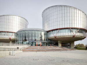 Since 1974 Swiss citizens have also been able to bring actions to assert the human rights guaranteed in the ECHR before this Court in Strasbourg. The Court has met in this building, designed by architect Richard Rogers to resemble a set of scales from above, since 1995. European Court of Human Rights in Strasbourg, photographed by Christian Beutler, 2018.