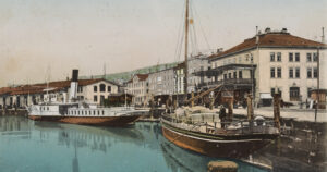 The port of Rorschach around 1902, with paddle steamer and barge.