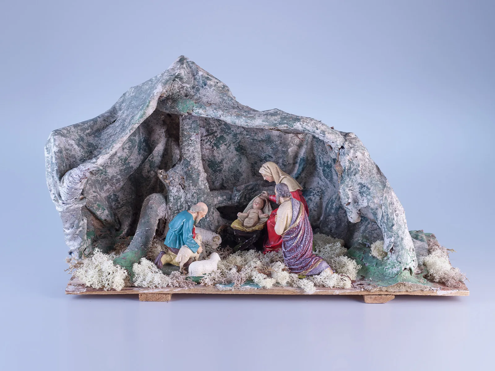 Diese Krippenszene zeigt die Geburt Jesu in einer einfachen Höhle. Sie ist aus Ästen konstruiert und mit einem bemalten Textil überzogen. Geschaffen wurde die Krippe von Nonnen des Klosters Heiligkreuz Cham um 1930.