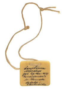 Anneliese Laupheimer’s identification tag with name and address in Switzerland. The tag, from the 1940s, was probably worn around the neck.