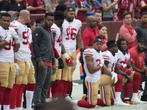 Players of the San Francisco 49ers American football team kneel during the national anthem in protest against racism, 2017.