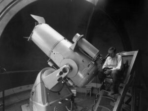 Fritz Zwicky looking into space using the then brand-new Schmidt telescope in 1936.